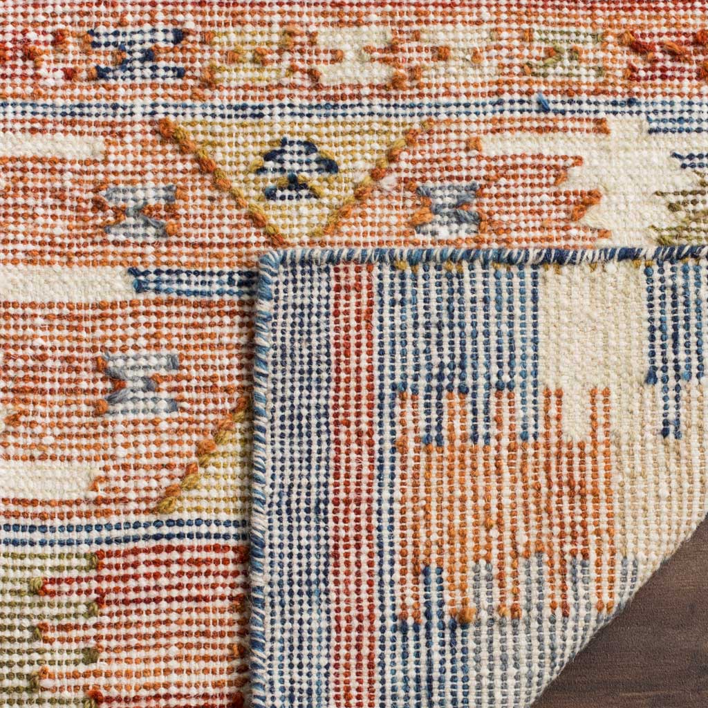 A folded edge reveals the rug's woven underside with narrow blue and rust stripes