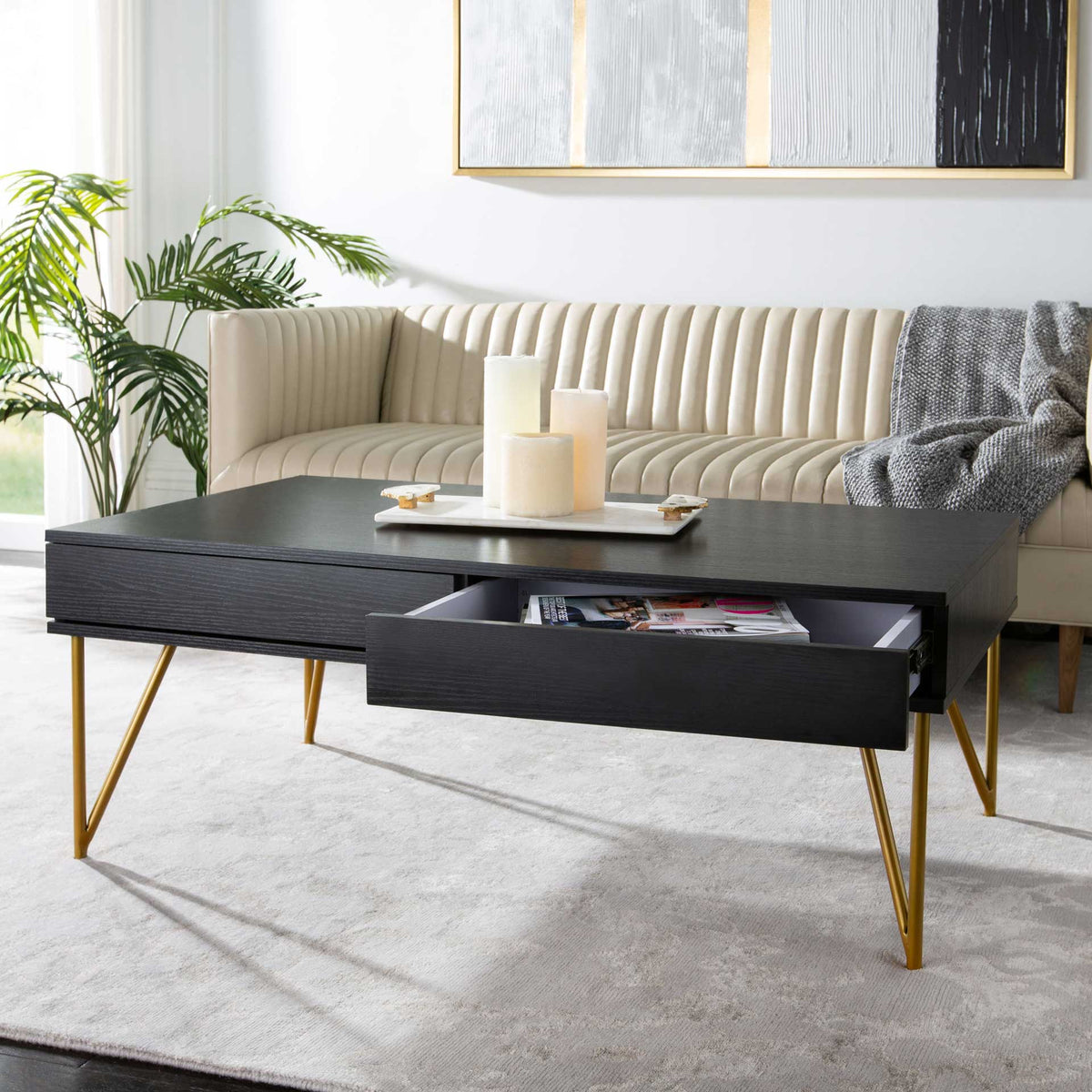 A deep drawer holds reading material beneath the sleek black tabletop.