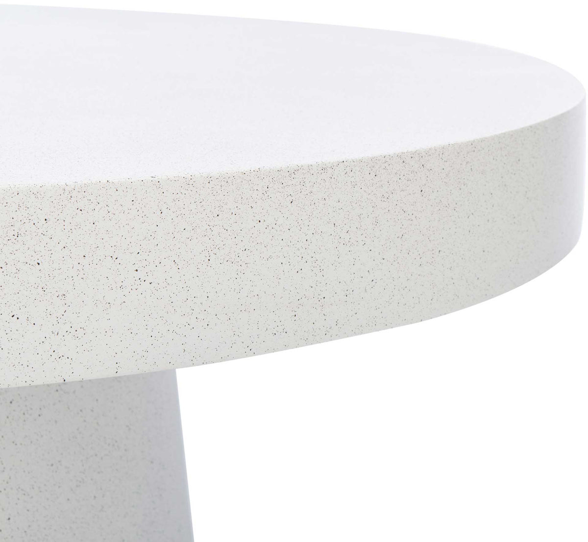 Fine speckles accent the thick, gently rounded edge of the white tabletop.