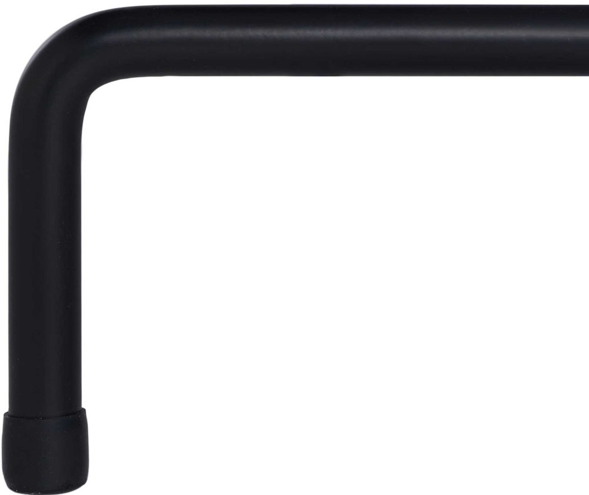 A bent black iron support ends in a neatly capped foot beneath the coffee table.