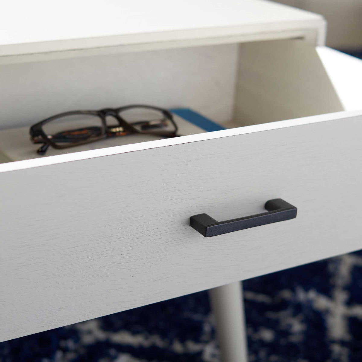 A roomy white drawer stores reading glasses and other small essentials within easy reach.