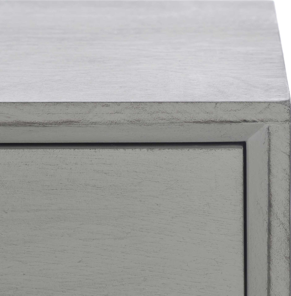 Subtly worn edges frame the gray drawer, adding texture beneath the smooth tabletop.