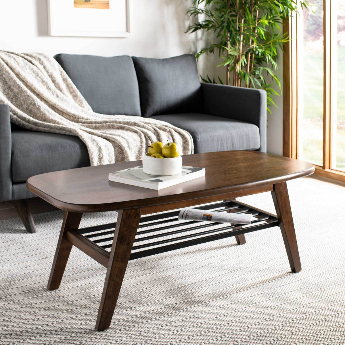 A warm walnut-finish top holds everyday accents while the black metal shelf keeps reading material close.