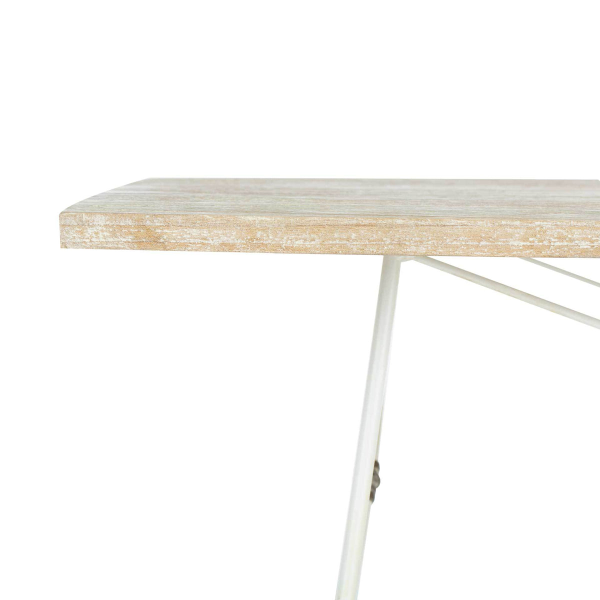 The whitewashed wood tabletop edge pairs weathered grain with a slender metal framework.