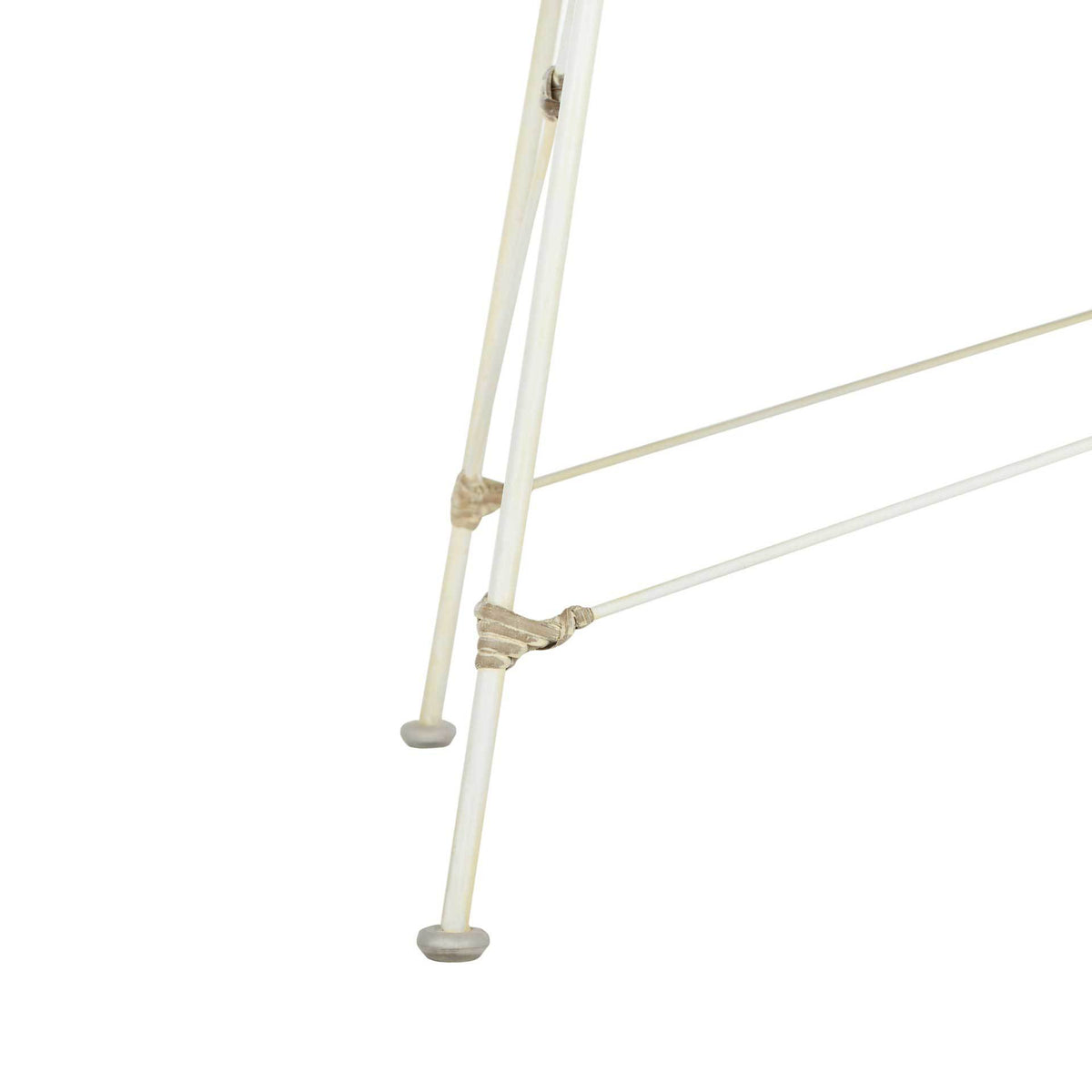 White steel legs and diagonal braces meet at textured joints above rounded feet.