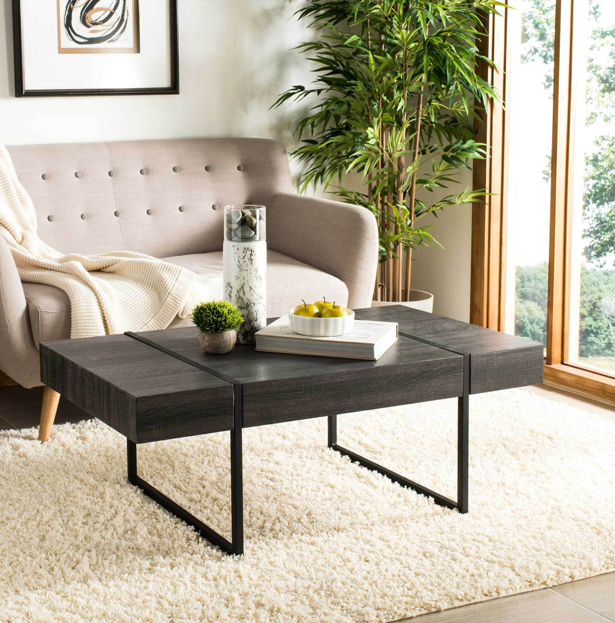 Black wood grain and slim metal supports bring modern contrast to a cozy living space.