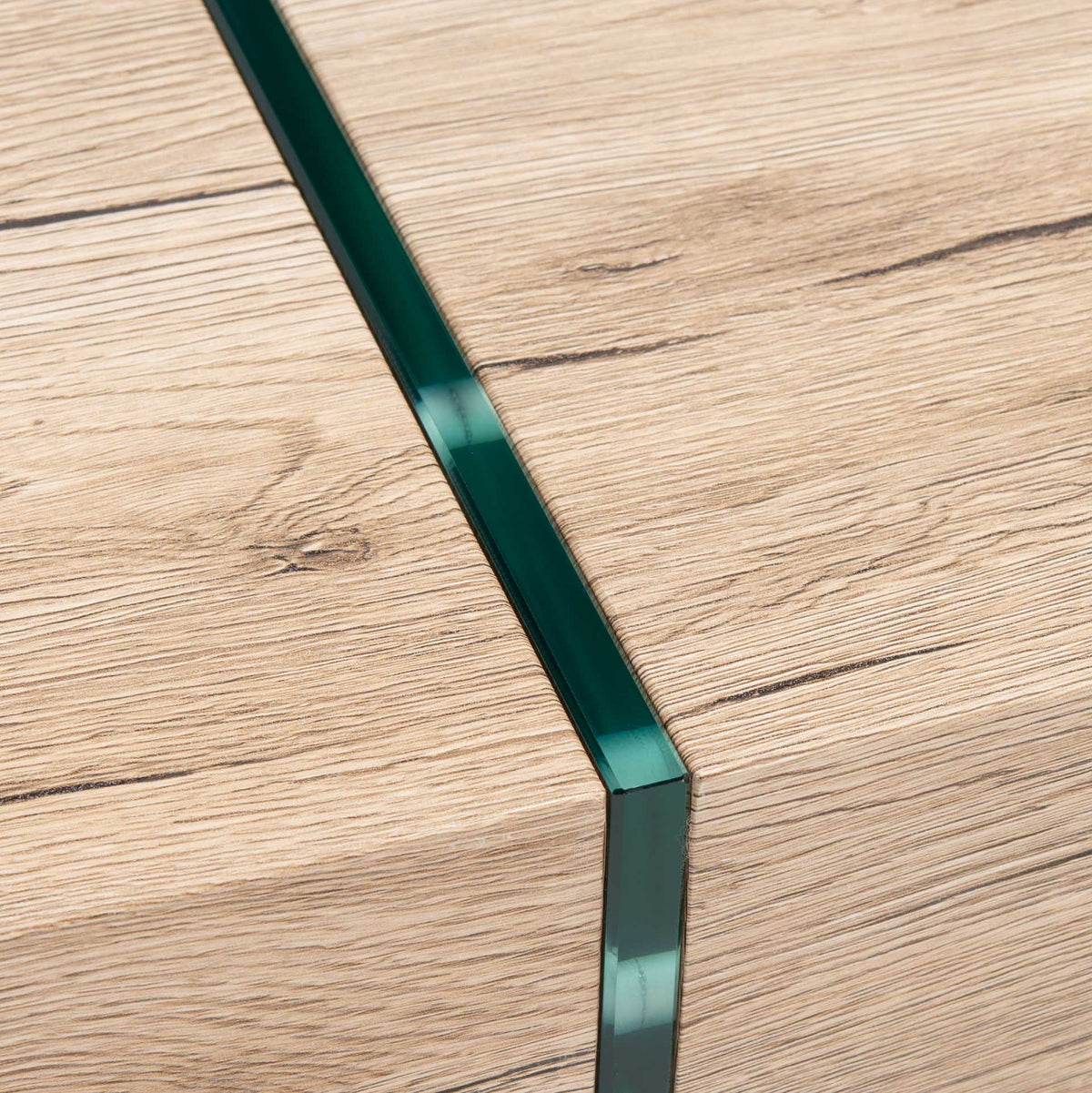 Green-edged glass cuts a crisp line through the textured wood-look tabletop.