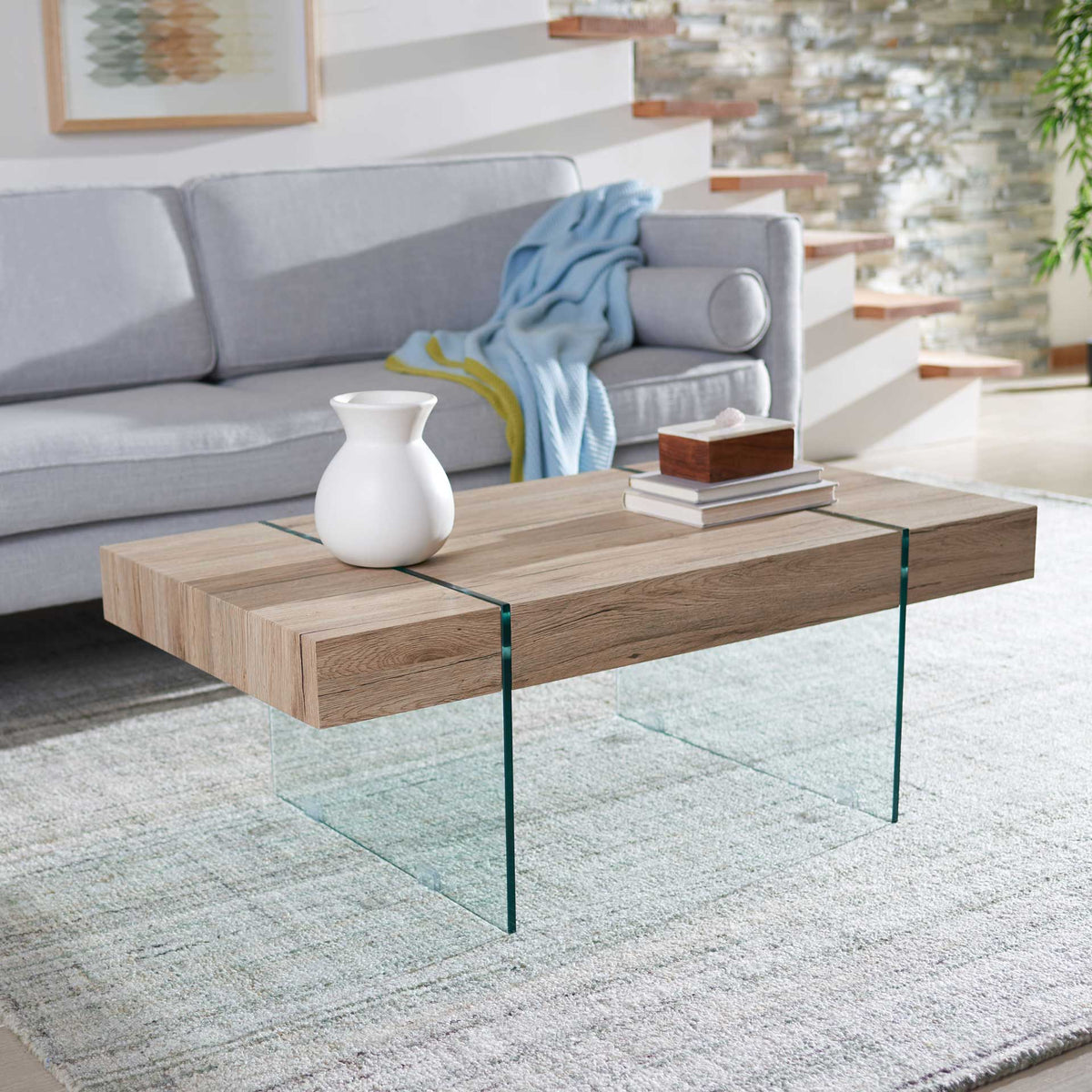 A natural wood-grain tabletop and clear glass legs make an airy living room centerpiece.