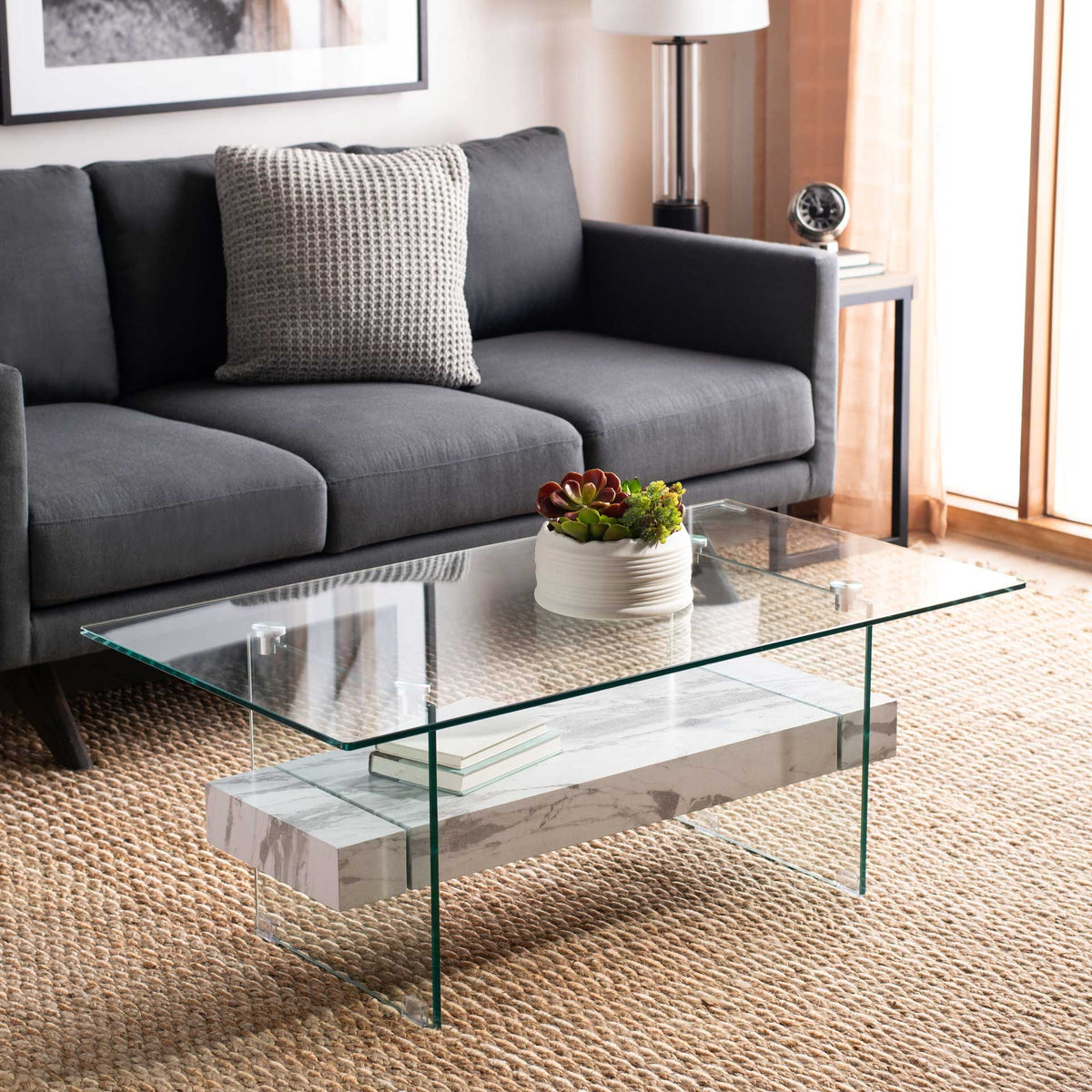 A white marble-look shelf brightens the sleek glass top and transparent supports