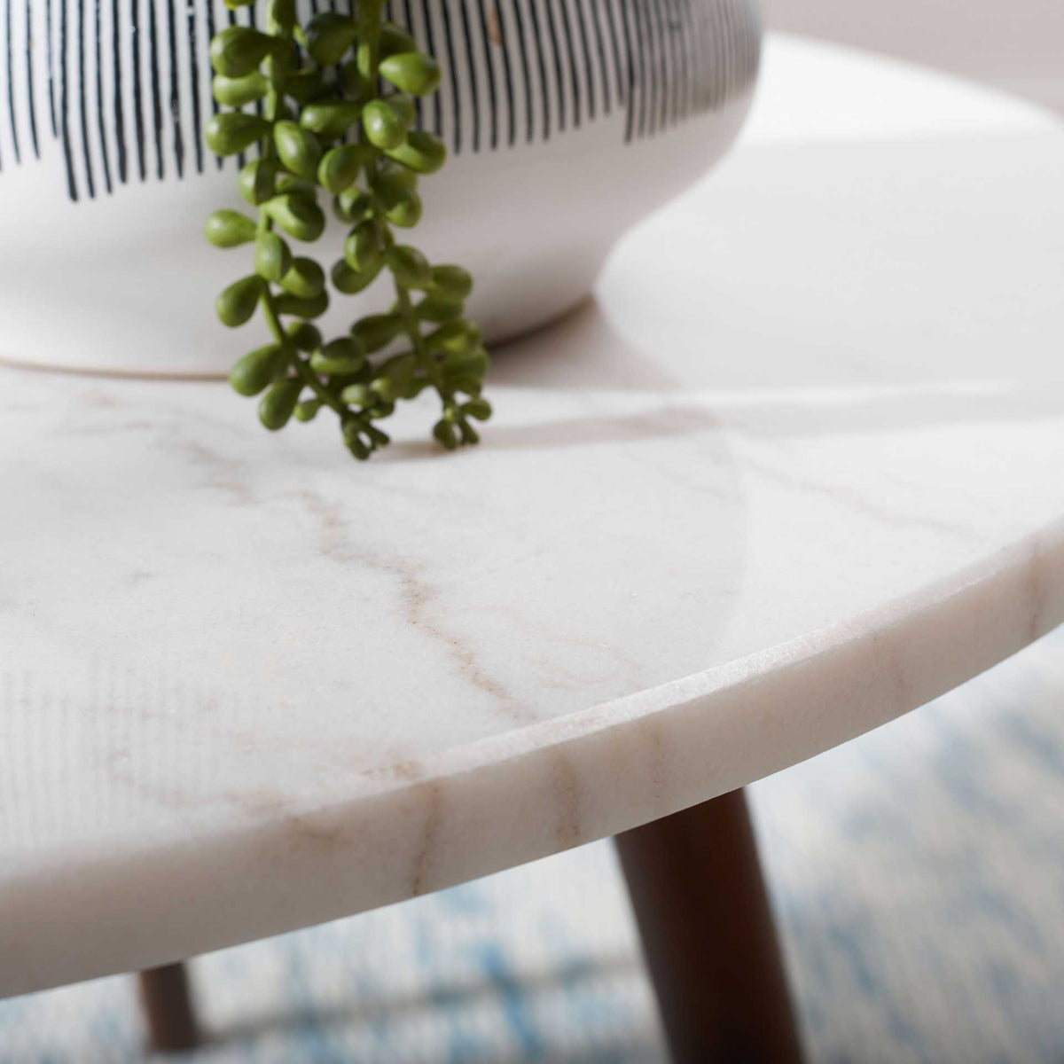 Subtle gray and beige veining brings natural variation to the white marble tabletop