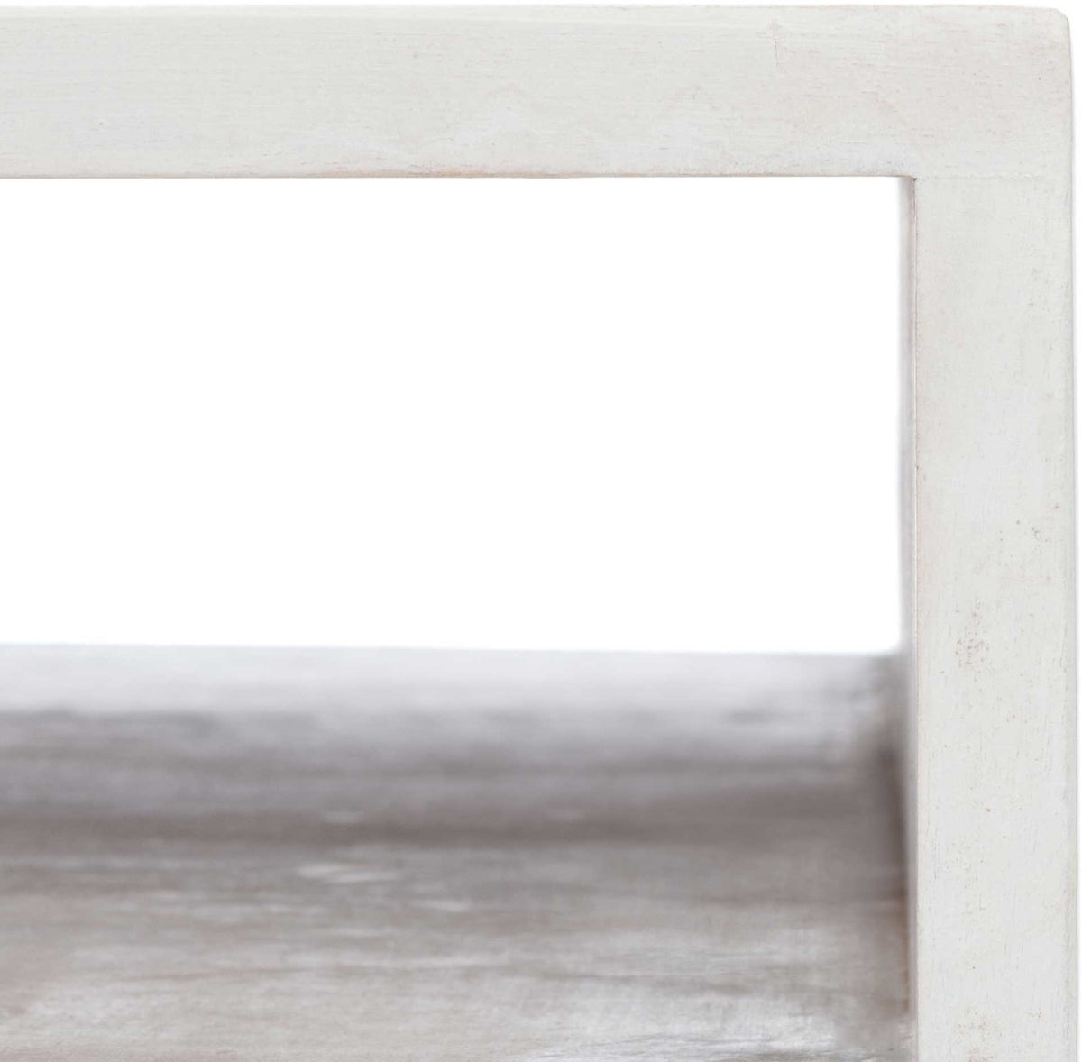 A whitewashed frame borders an open storage nook with a softly textured wood shelf.