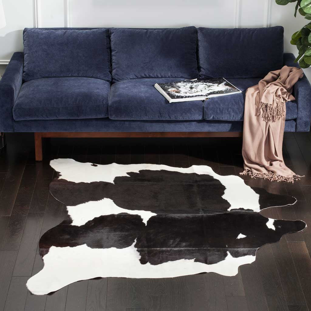 Bold black and white cowhide adds graphic contrast and natural texture to a living room.