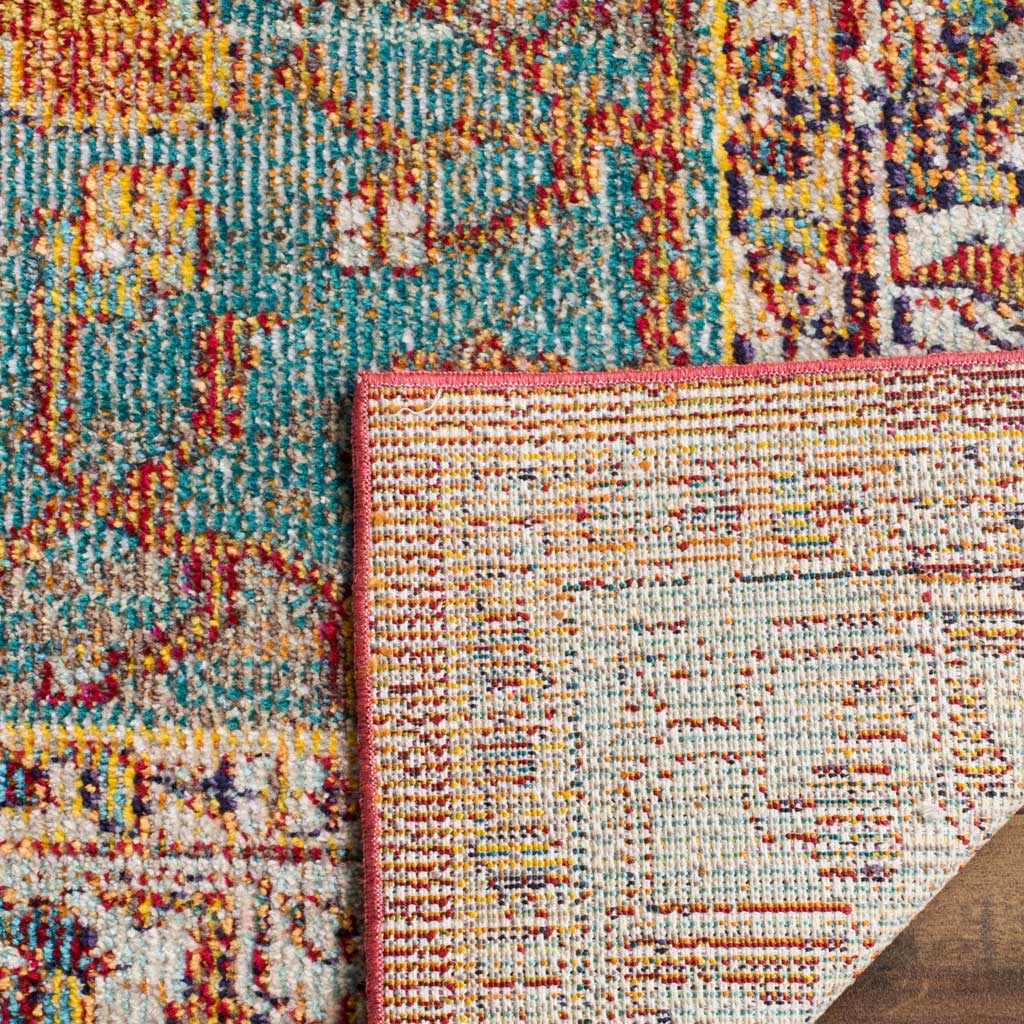 A turned corner reveals woven backing, a red bound edge, and colorful patterned pile.