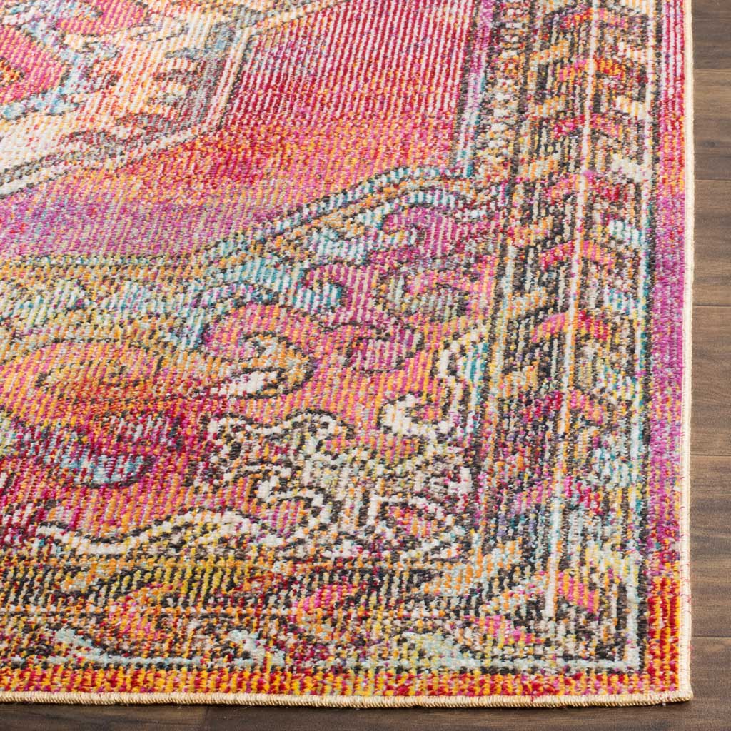 A finely bound edge finishes colorful scrollwork woven in pink, orange and light blue.