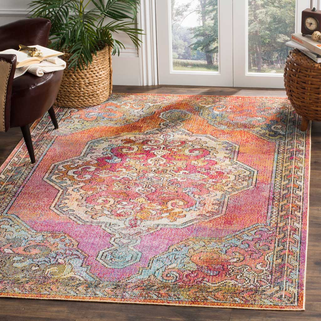 A richly patterned rug brings an ornate medallion and vivid orange, pink and blue tones to a bright living space.