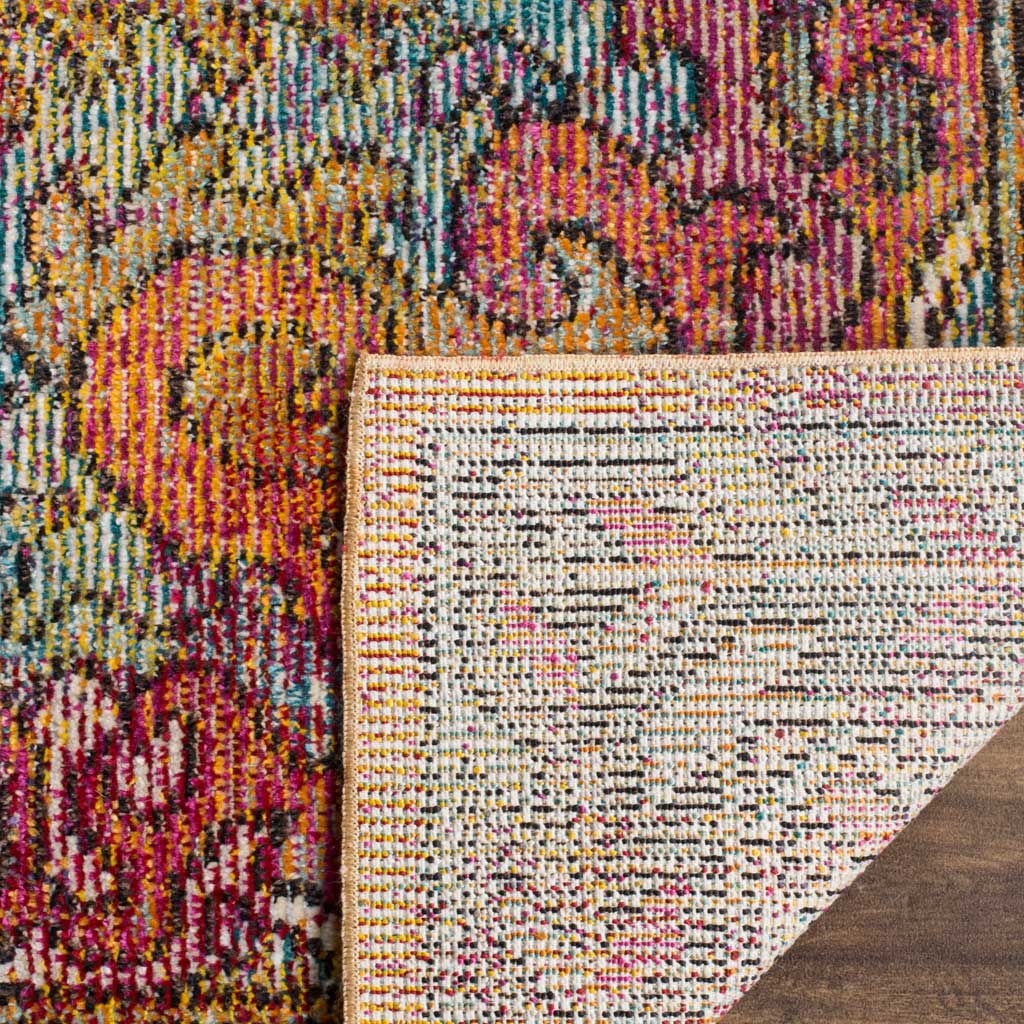 A folded edge reveals the rug's closely woven backing beneath its vibrant, multicolored surface.