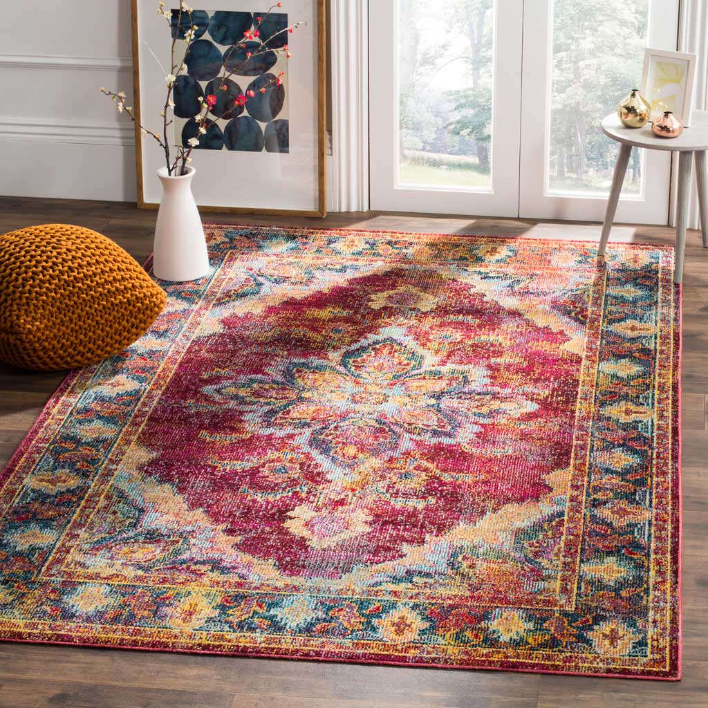 Ruby and navy medallion rug brings vivid color to a room with a woven pouf and slender side table