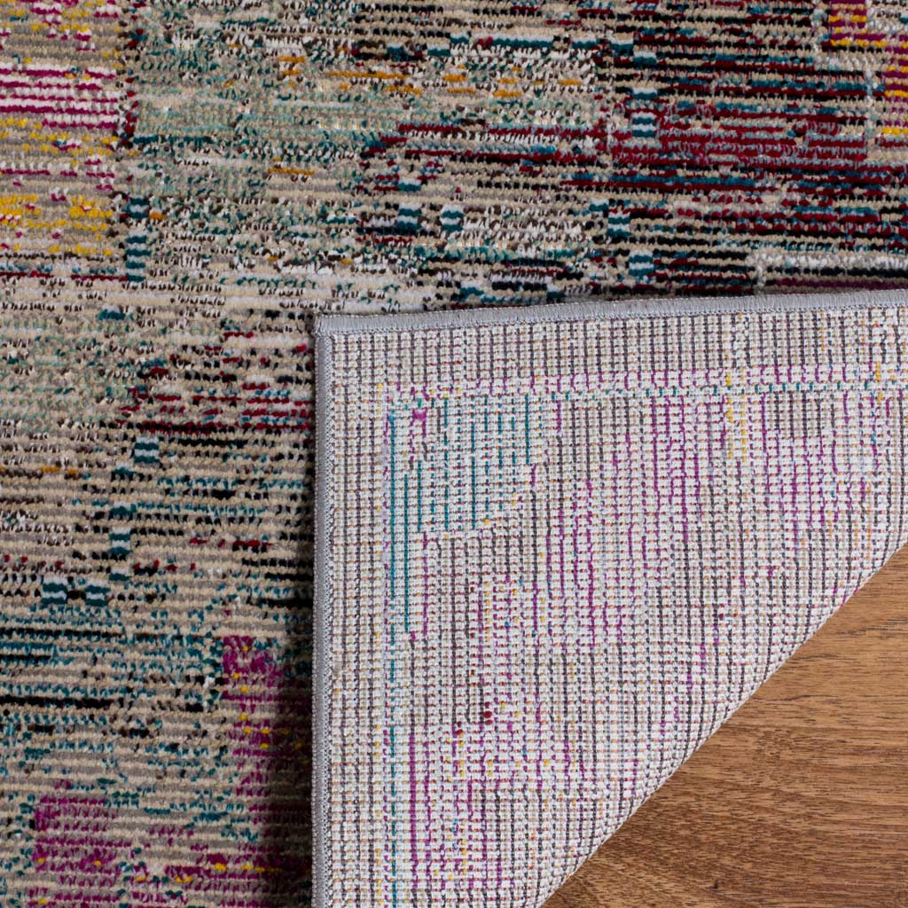 A folded corner reveals woven cotton backing beneath a richly colored, low-profile pile.