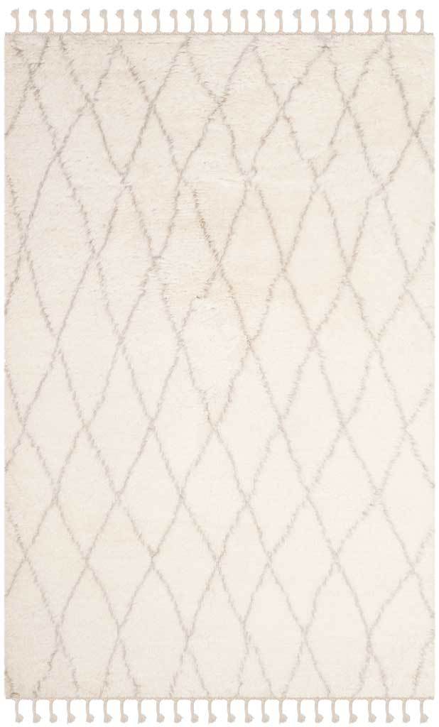 Light ivory pile features a slim gray diamond lattice and knotted end tassels