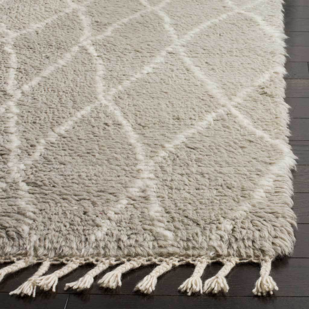 Diamond-patterned gray wool pile meets a row of thick ivory fringe tassels