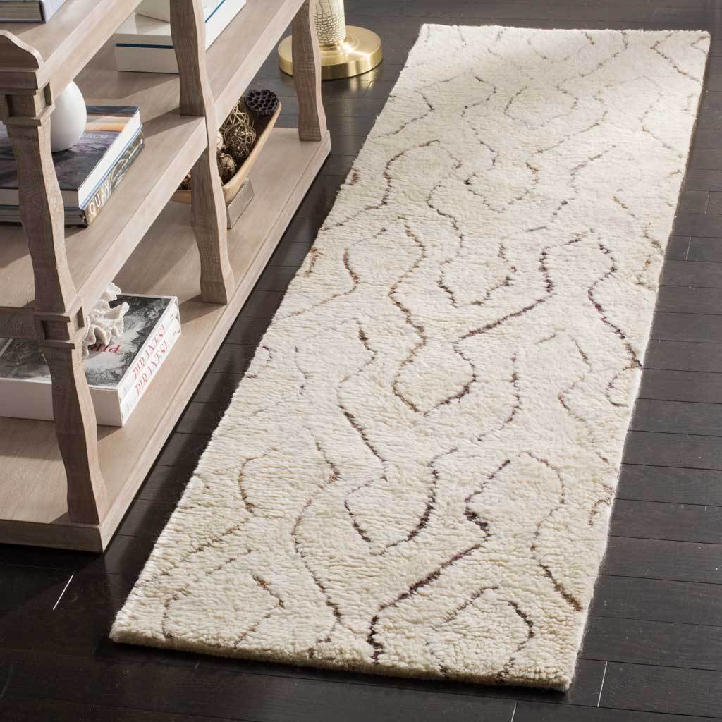 Soft ivory runner adds warmth and texture with gently winding lines in muted colors