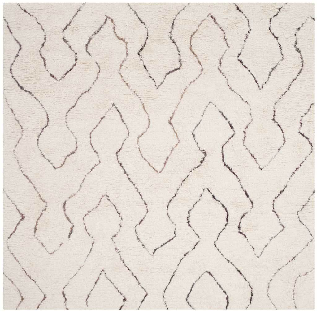 A square ivory shag rug features flowing geometric lines in subdued charcoal and rosy tones.