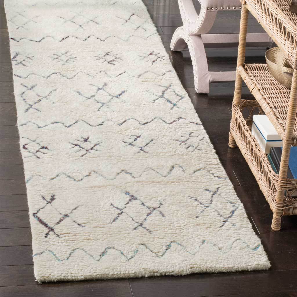 Plush ivory runner with subtle geometric patterns contrasts with dark wood floors