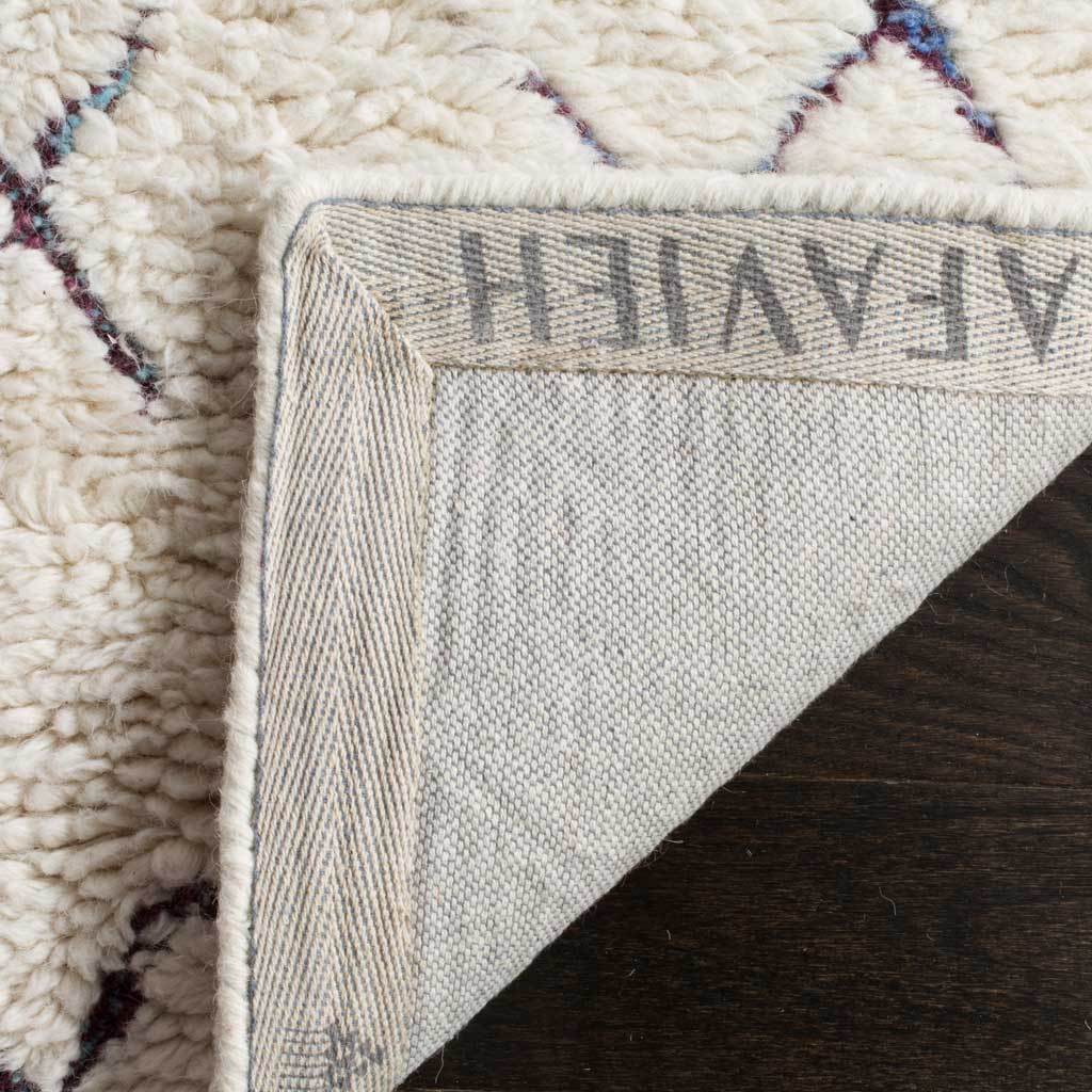 A turned-back corner reveals woven fabric backing beneath the soft, patterned ivory pile.