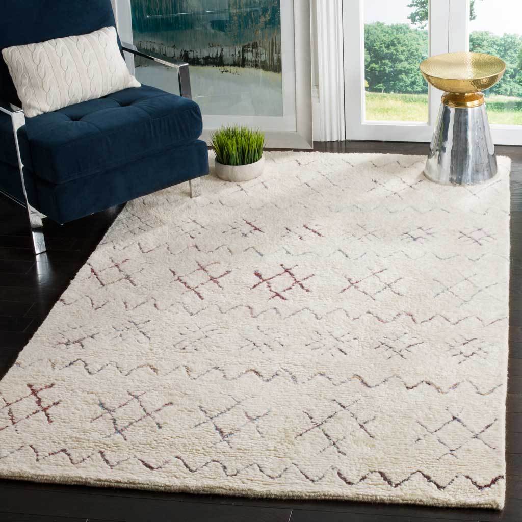 An ivory rug with colorful geometric motifs anchors a bright, modern living space.
