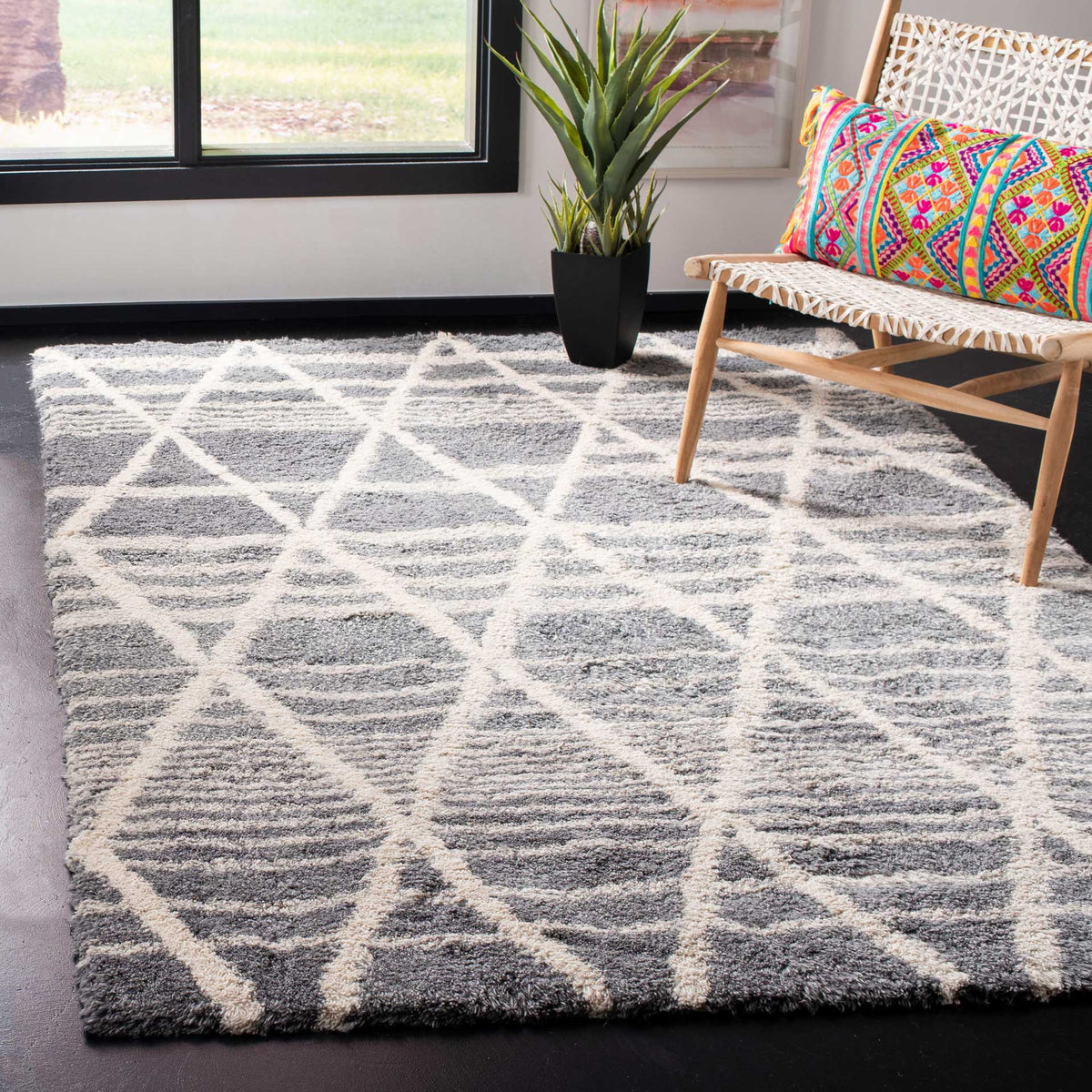 A plush gray-and-ivory rug grounds a bright room with graphic diamond texture.