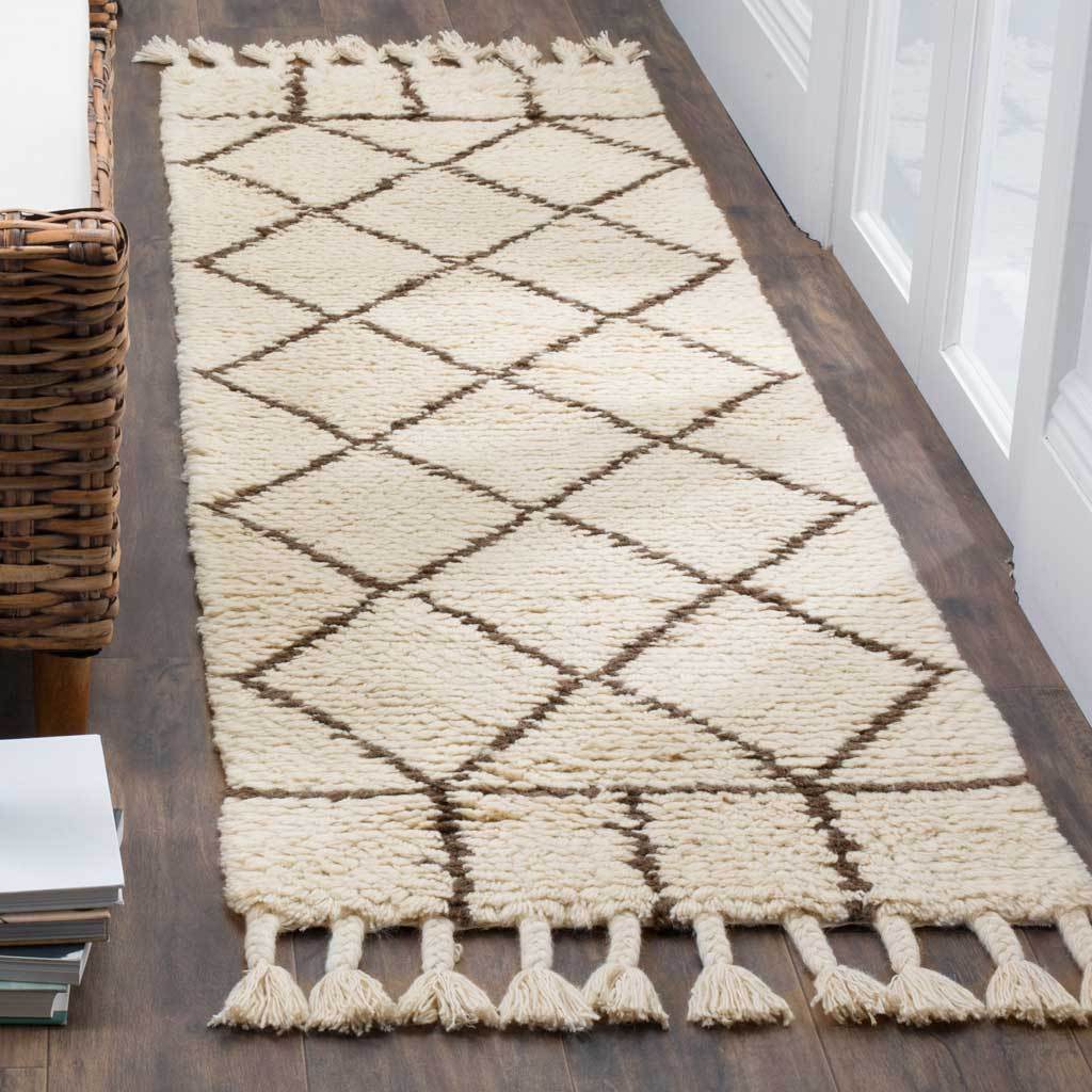 Soft ivory pile and a brown geometric lattice add warmth and texture to a hallway