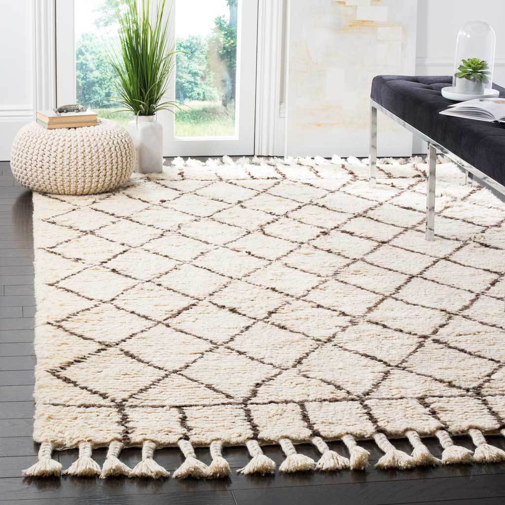 Ivory and brown diamond rug brings plush texture and fringed detail beneath a bench