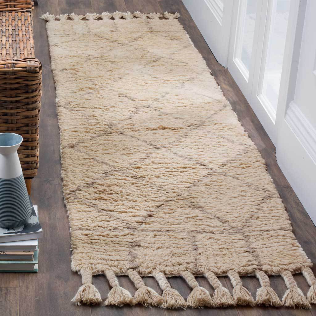 A soft ivory runner with muted gray accents and chunky tassels adds cozy hallway texture