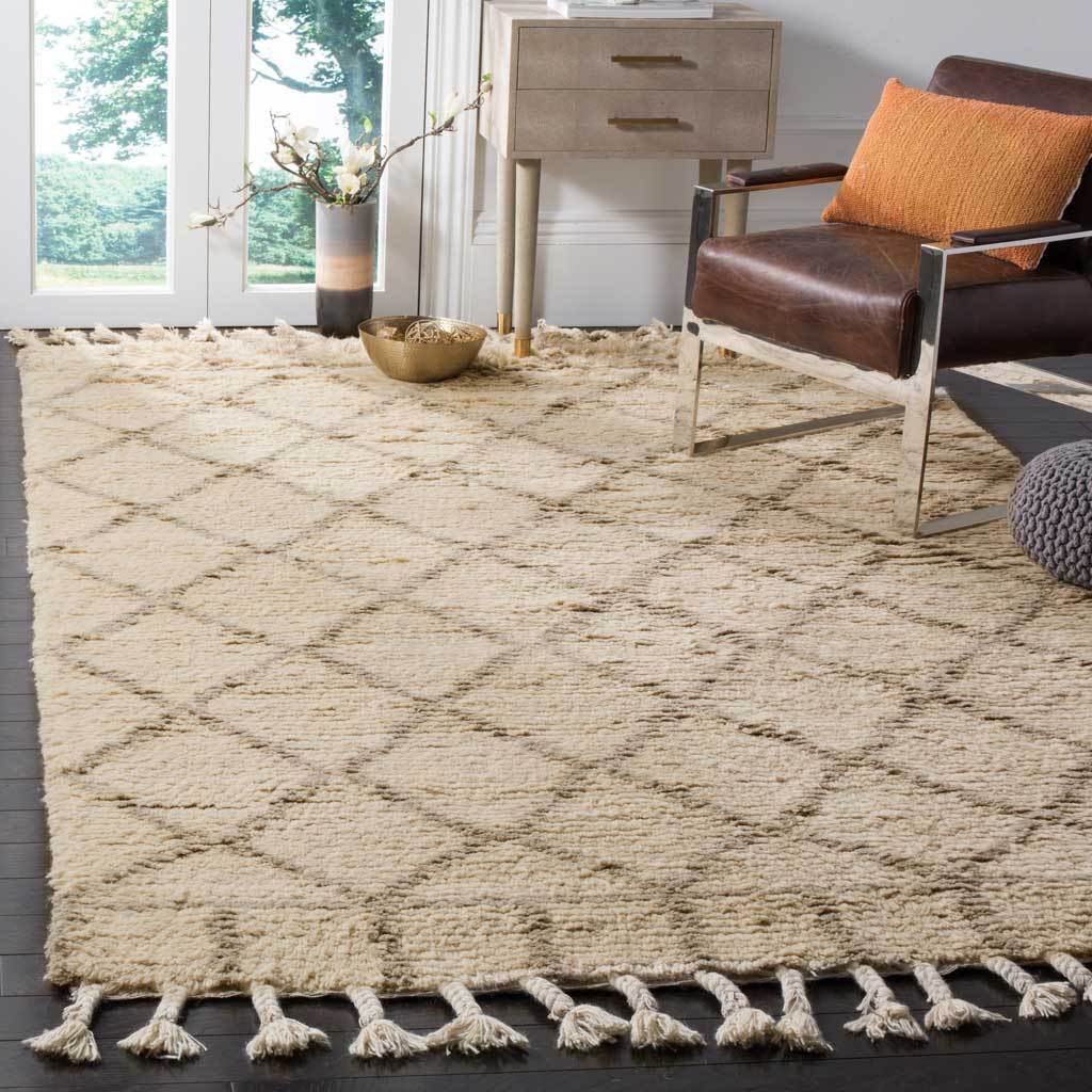 Ivory rug with a pale gray diamond lattice and fringe lends warmth to a living area