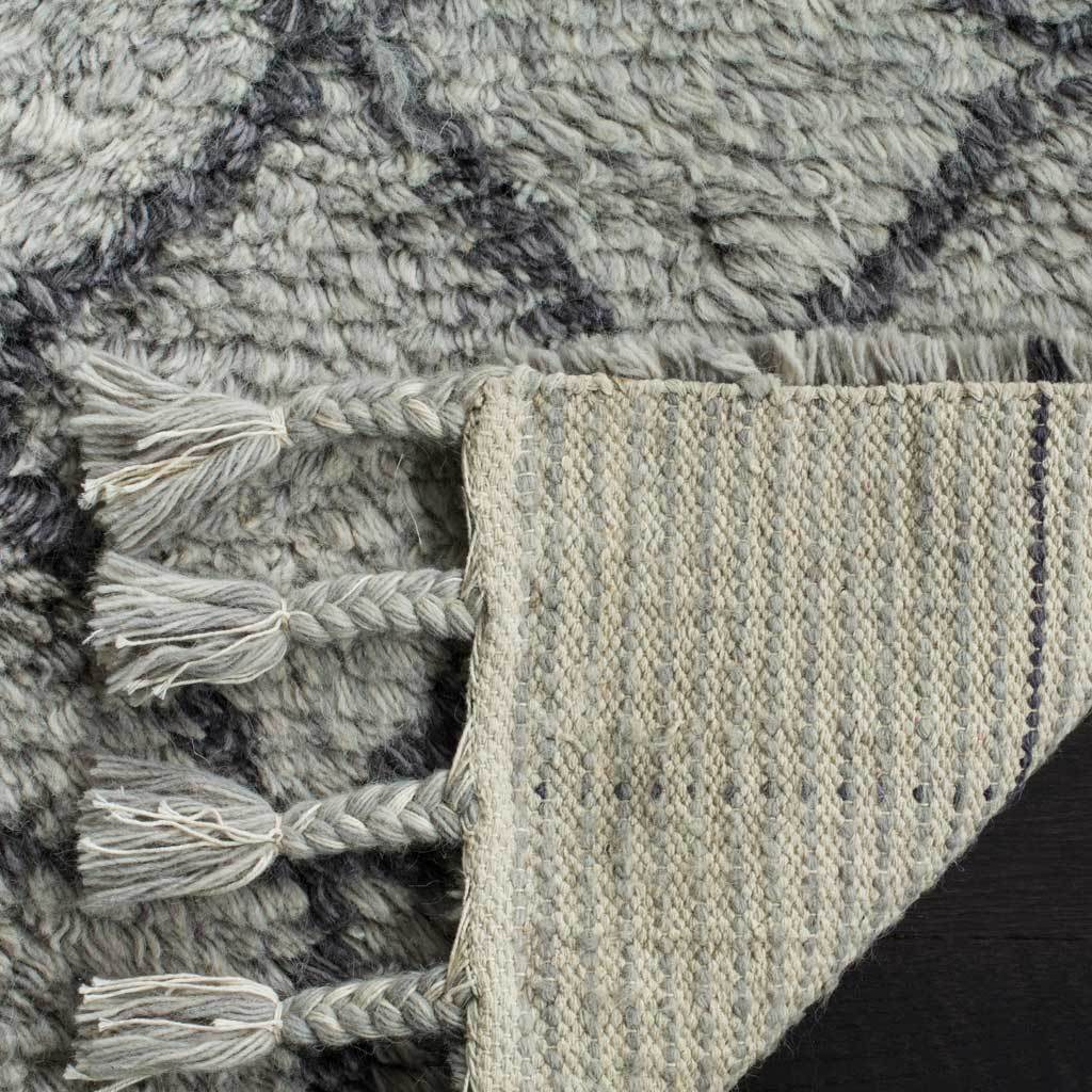 Woven underside contrasts with the soft gray pile and braided fringe
