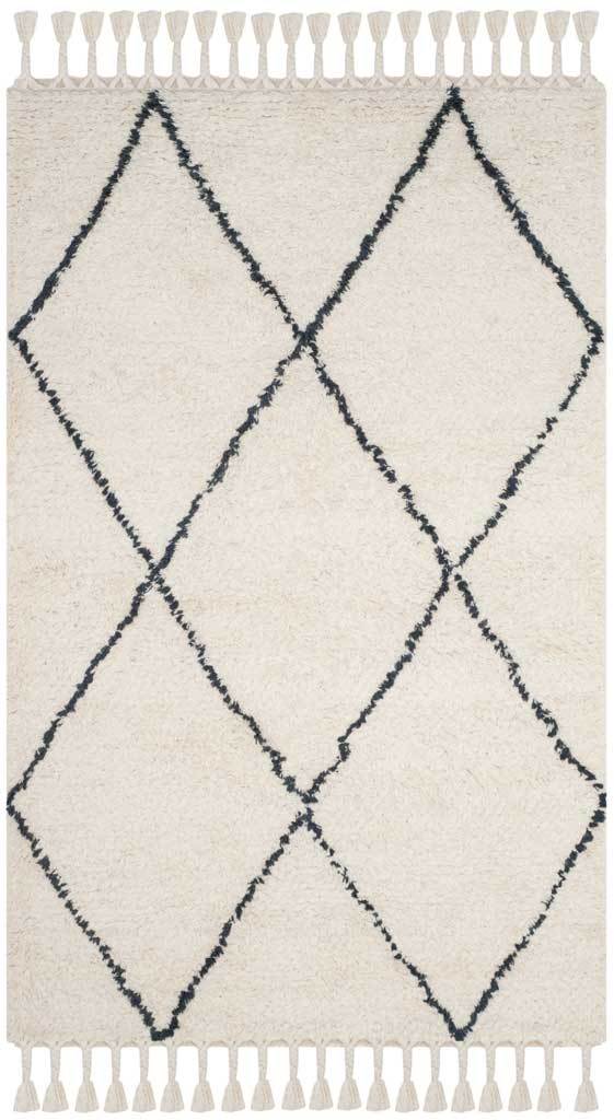 A soft ivory wool pile sets off oversized gray diamonds and tasseled ends.