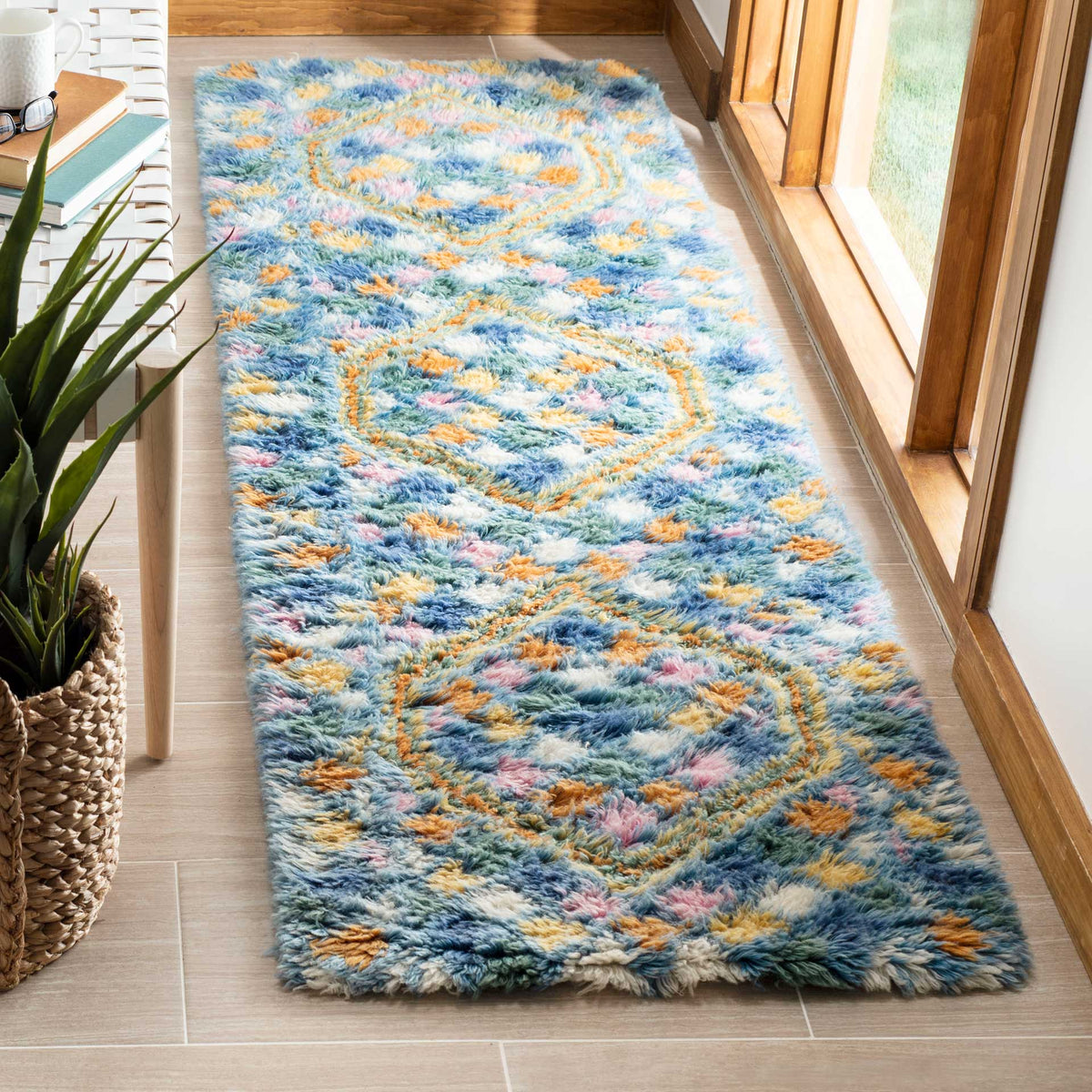 Soft light blue runner brightens the floor with gold and pink geometric motifs
