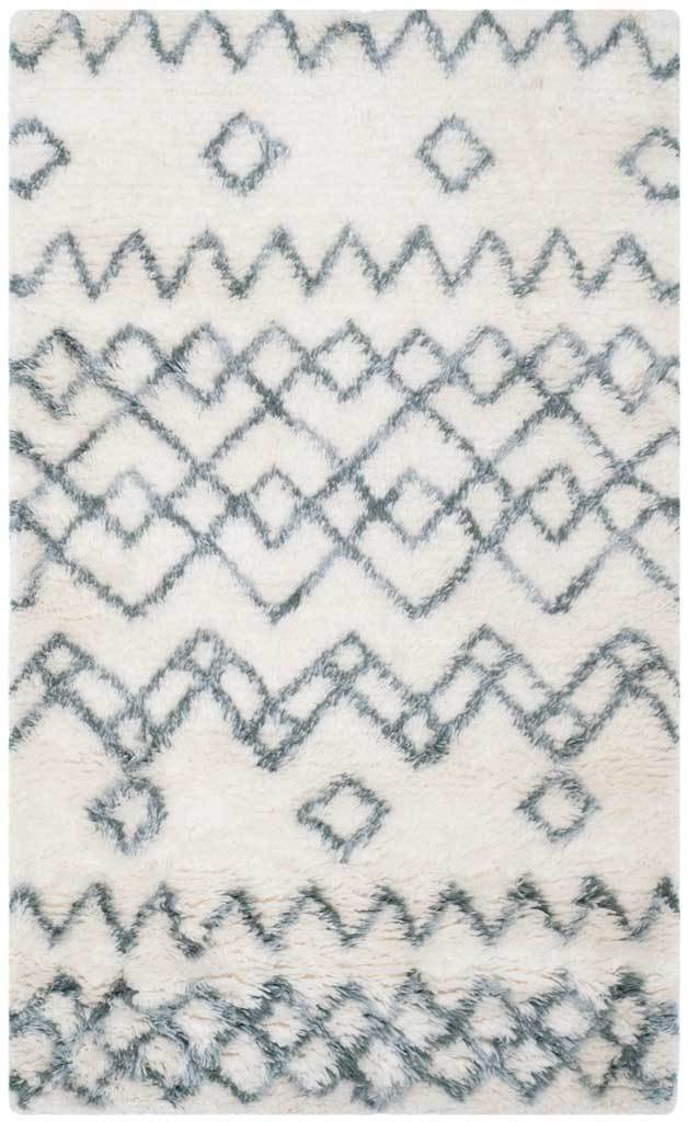 Ivory and blue rug showcases bold zigzags, open diamonds, and a soft, thick pile