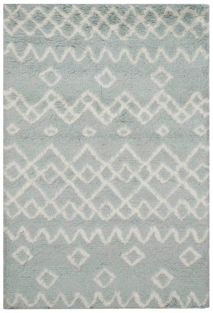 Plush blue and ivory rug pairs an airy diamond pattern with playful zigzag accents