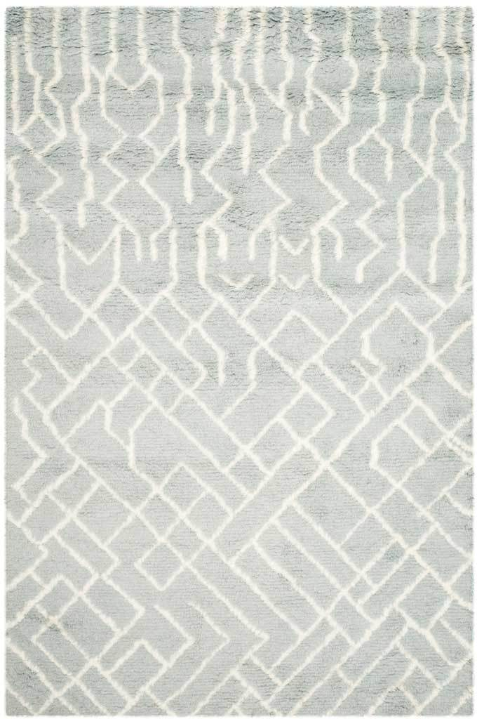 Ivory lines form loose diamonds across a plush, pale blue rectangular rug