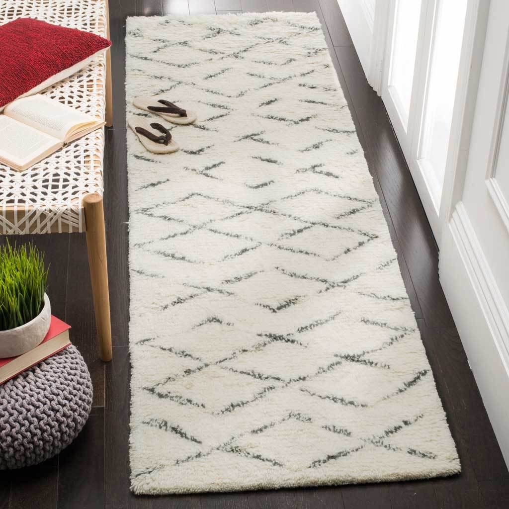 Ivory and gray geometric runner brings cozy texture to a narrow hallway
