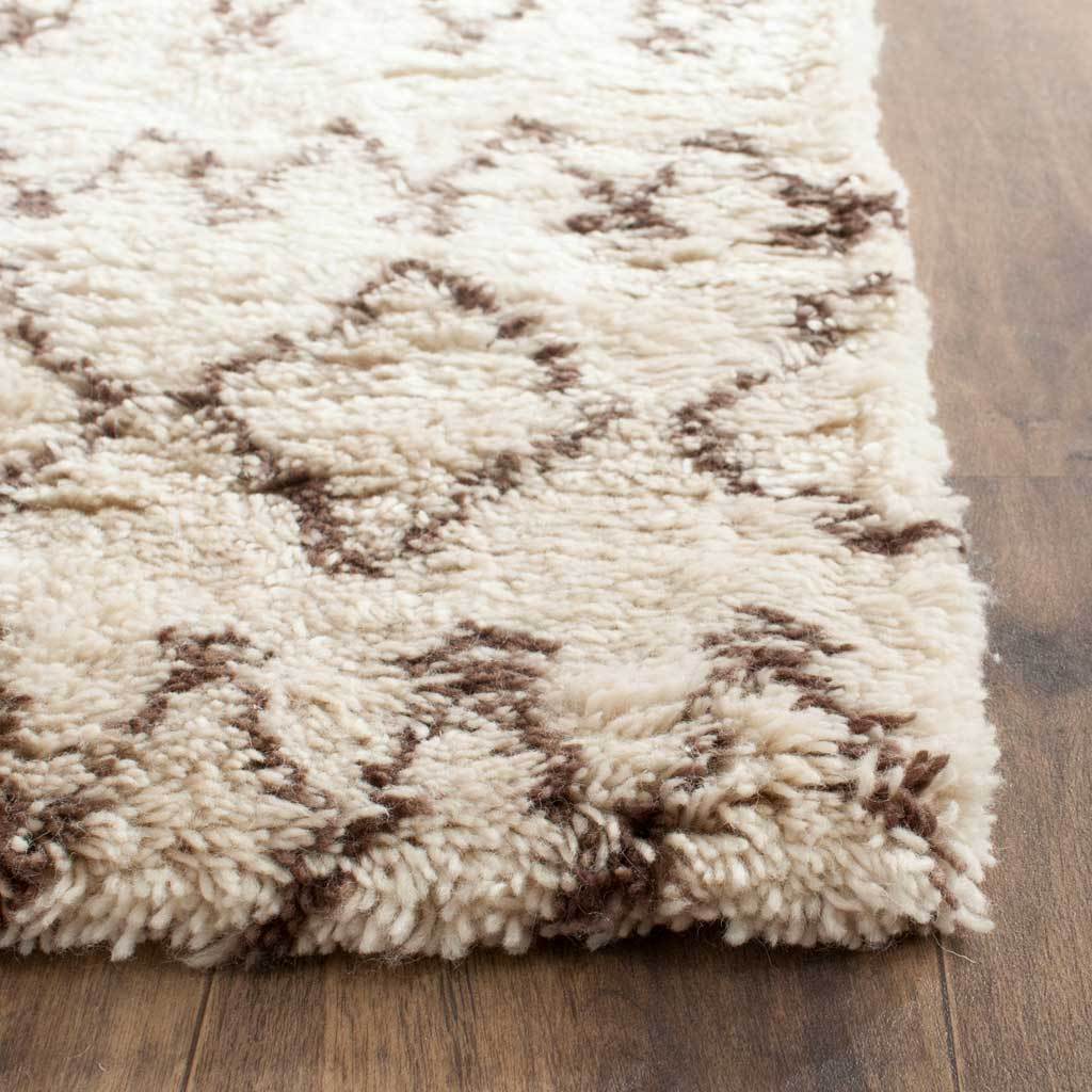 Thick ivory pile and dark brown geometric lines meet at the runner's textured corner
