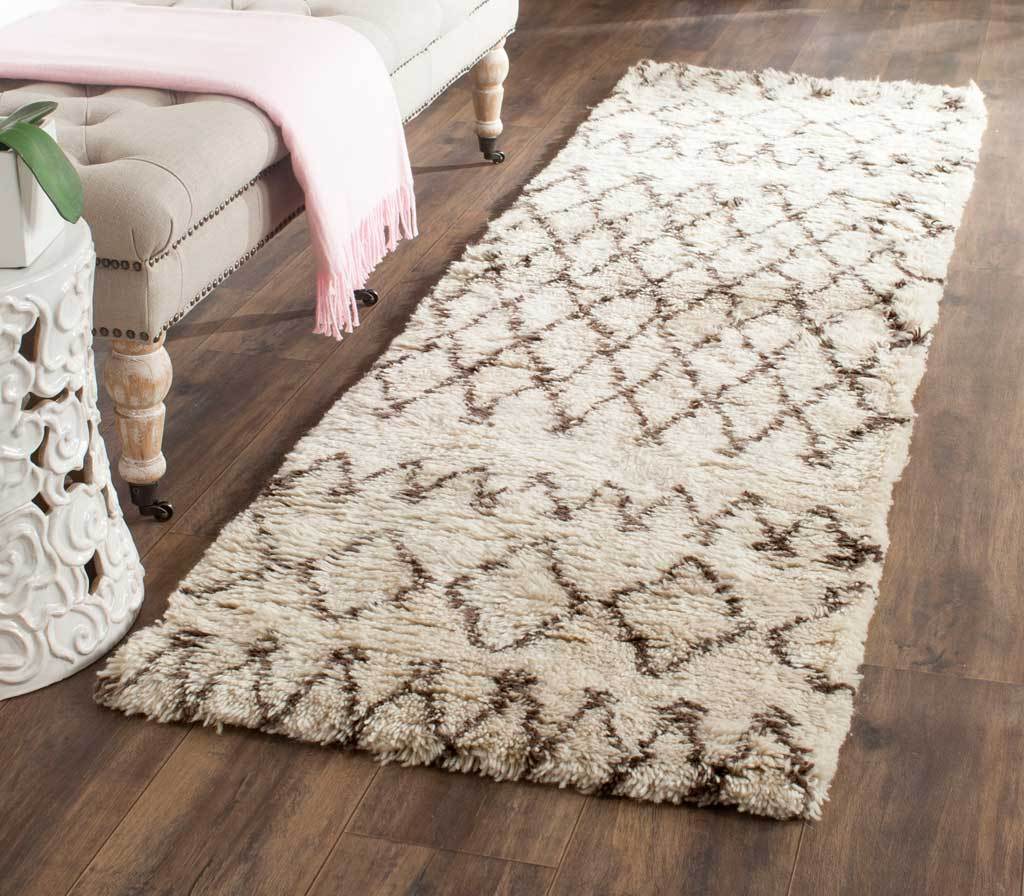 Plush ivory and dark brown runner adds bold diamond motifs and cozy texture beside a sofa