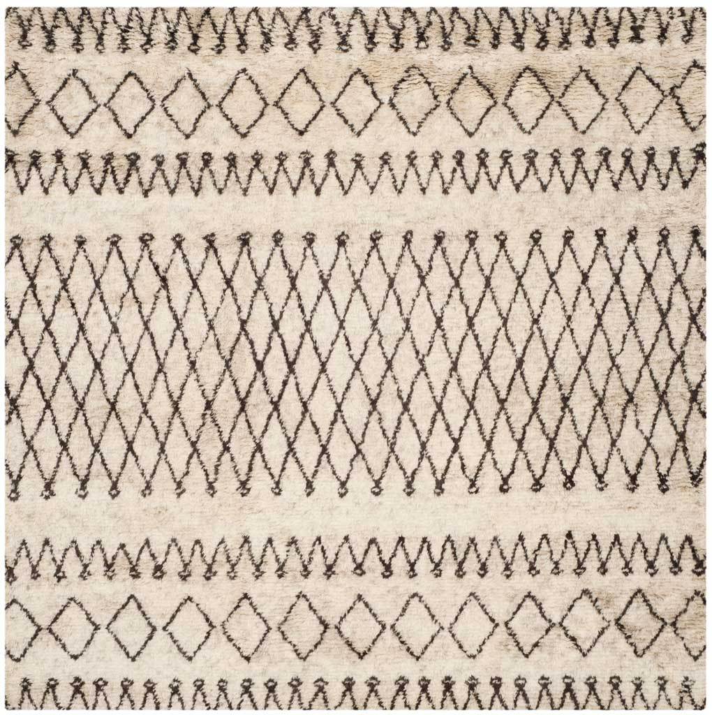 This square ivory rug combines a dense dark brown diamond lattice with zigzag bands at either end.