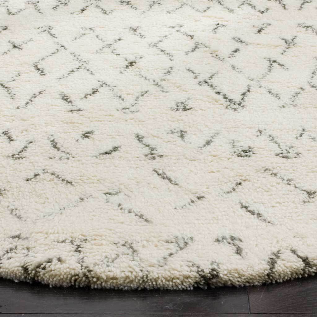 Thick ivory pile and wispy gray accents create a soft, textured surface