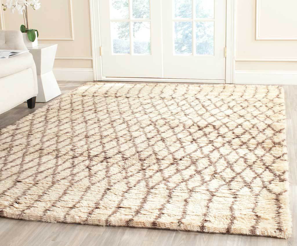 Ivory shag rug brings a relaxed gray diamond pattern and cozy texture to the floor.