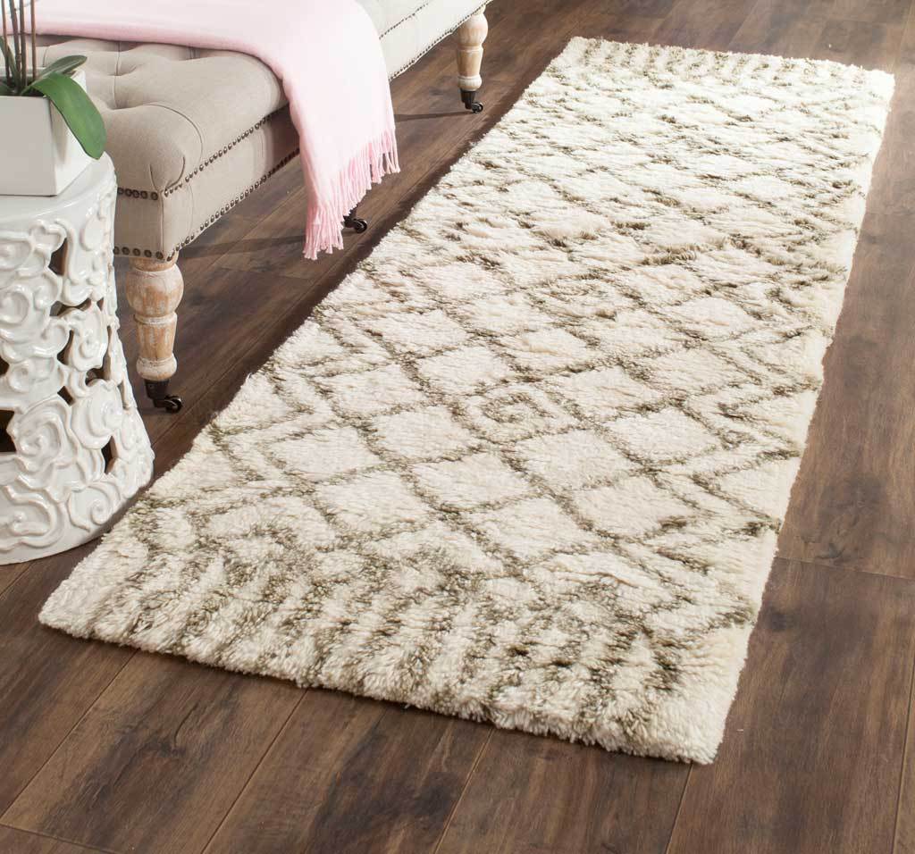 A plush ivory runner warms the room with earthy green diamonds and textured patterned ends.
