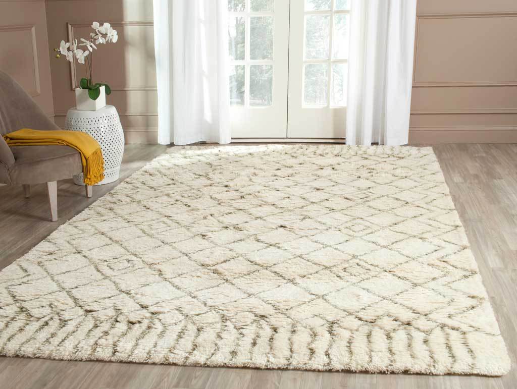 Ivory shag rug with a green diamond lattice warms a sunlit seating area