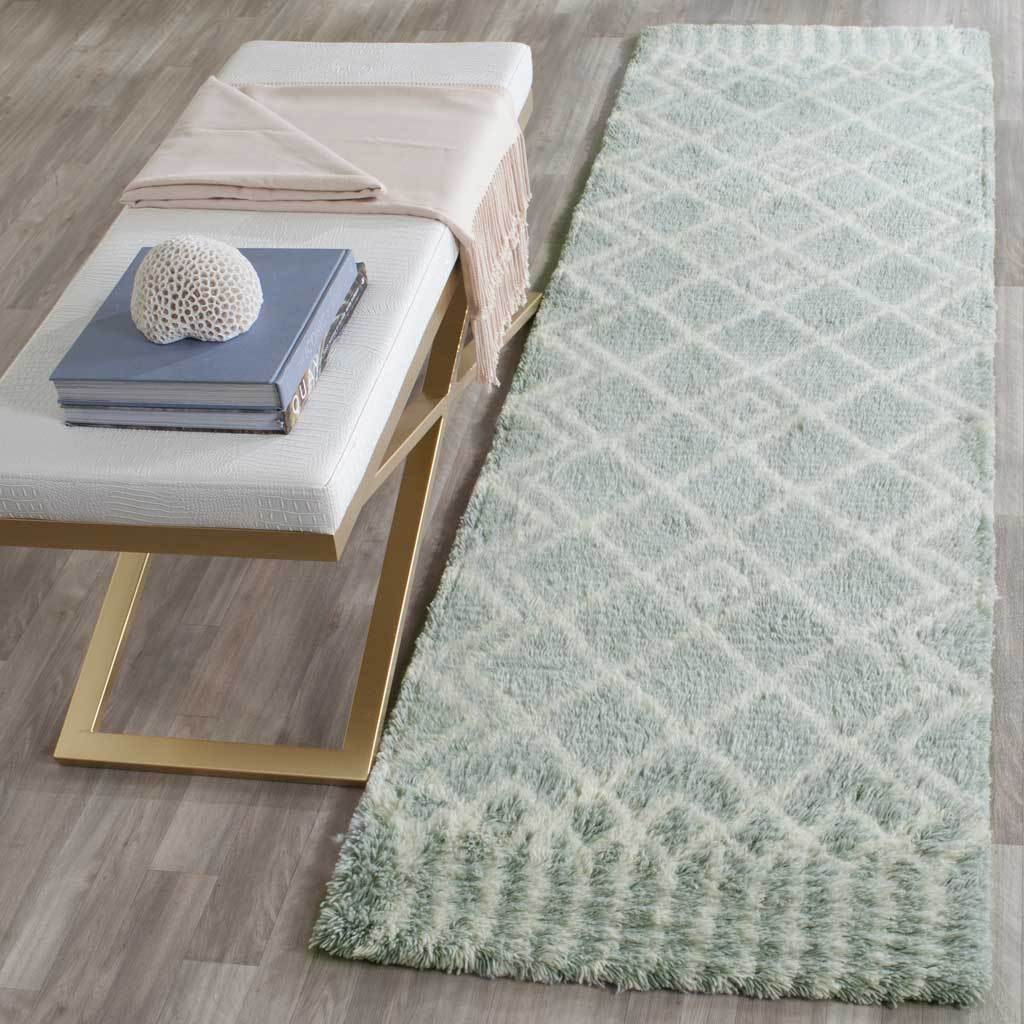 A plush blue and ivory runner adds warmth with its repeating diamond lattice and patterned ends.