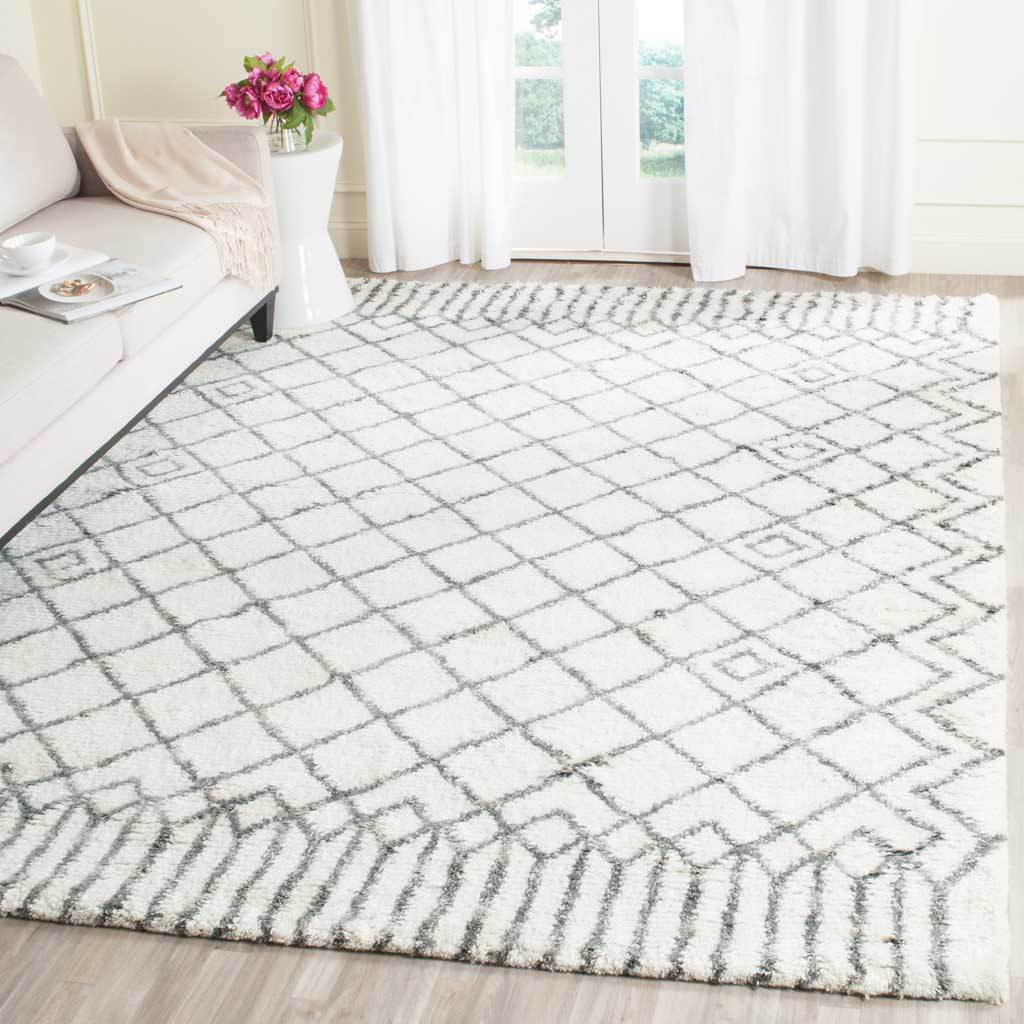 Gray diamond trellis adds crisp contrast to an ivory shag rug in a bright sitting area